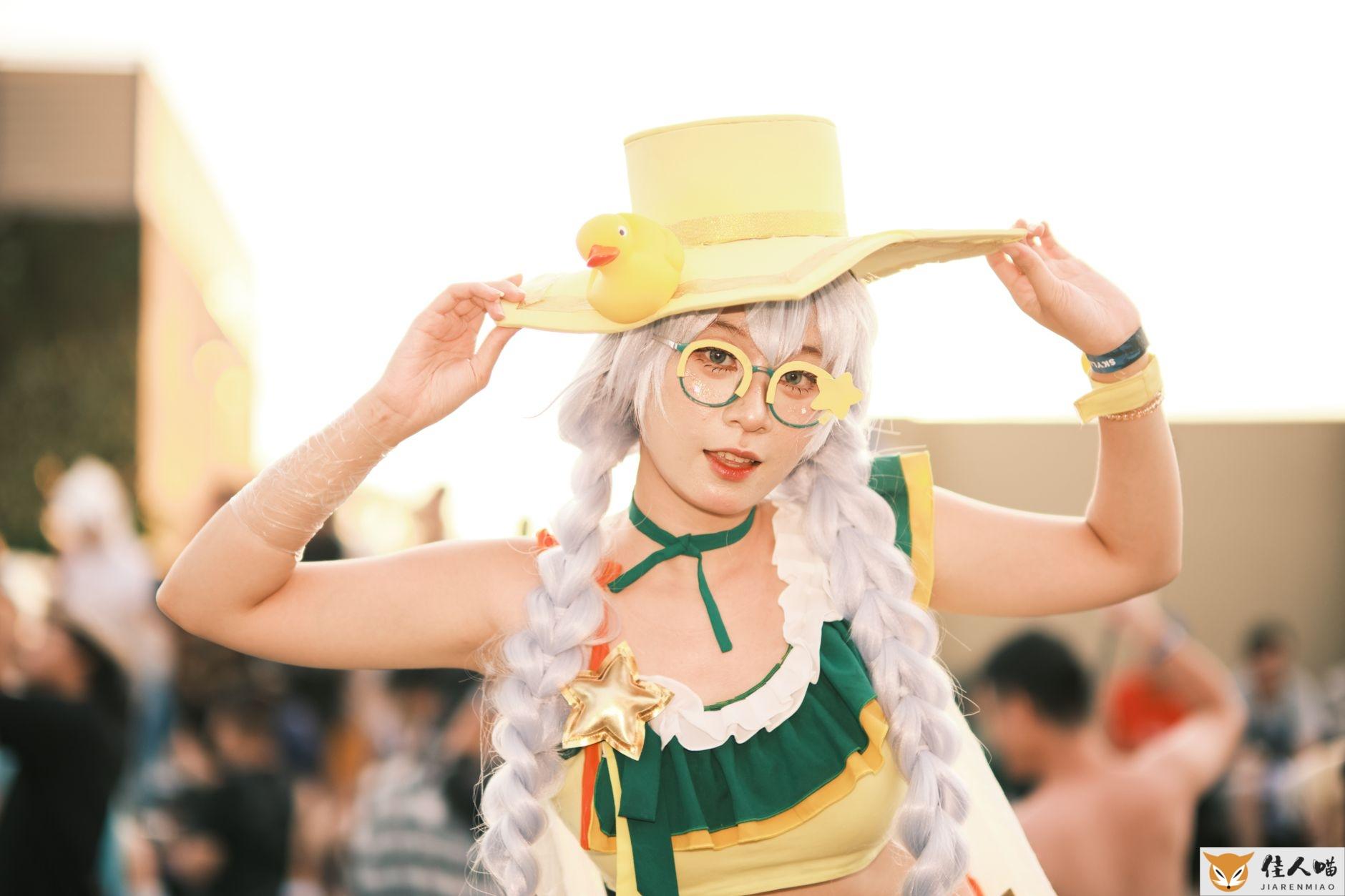 Vibrant cosplay character with yellow hat and unique accessories at an outdoor event.