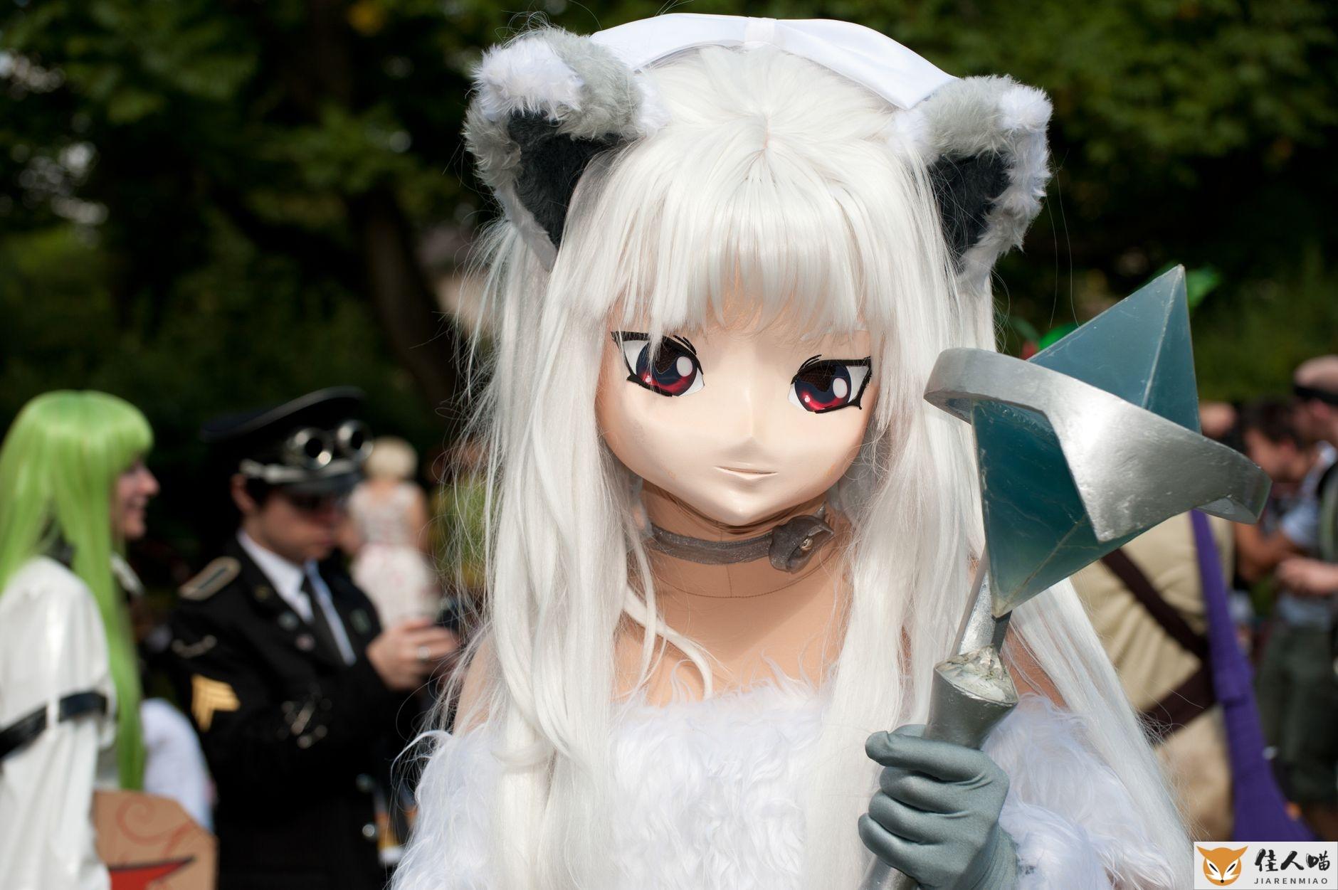A striking cosplay character with unique costume at an outdoor convention setting.