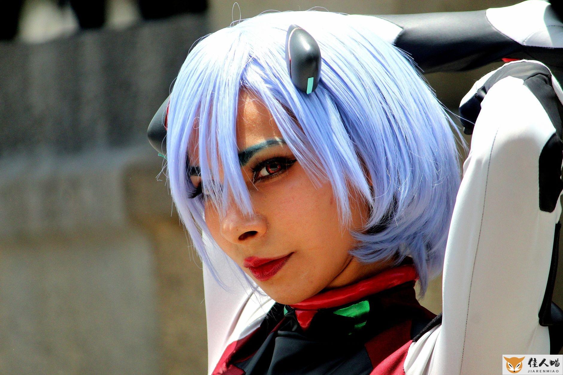 Portrait of a woman in anime cosplay with blue wig and costume, showcasing artistic expression.